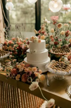 Floral three tier wedding cake dessert table