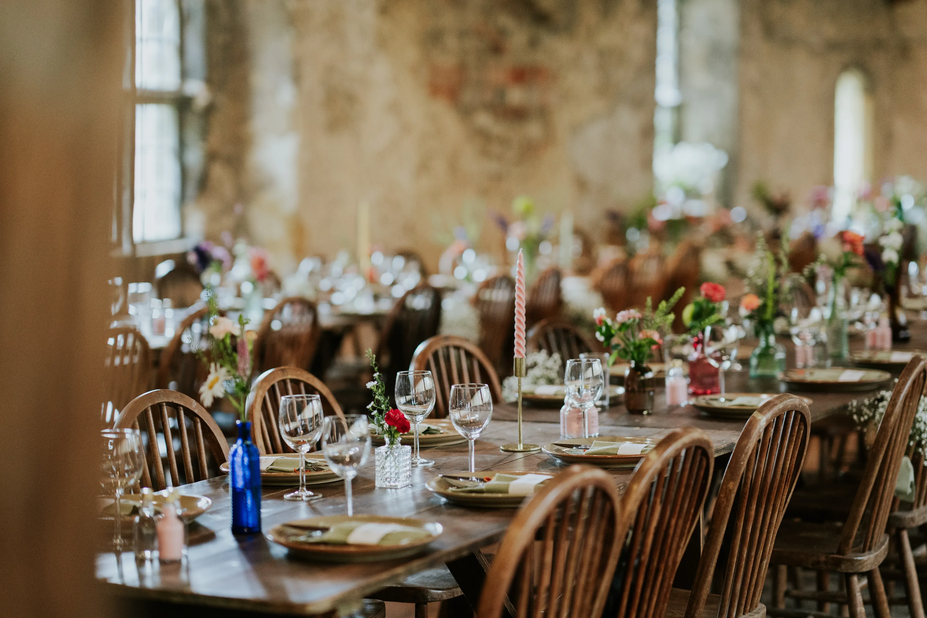 Rustic wedding reception long tables floral decor