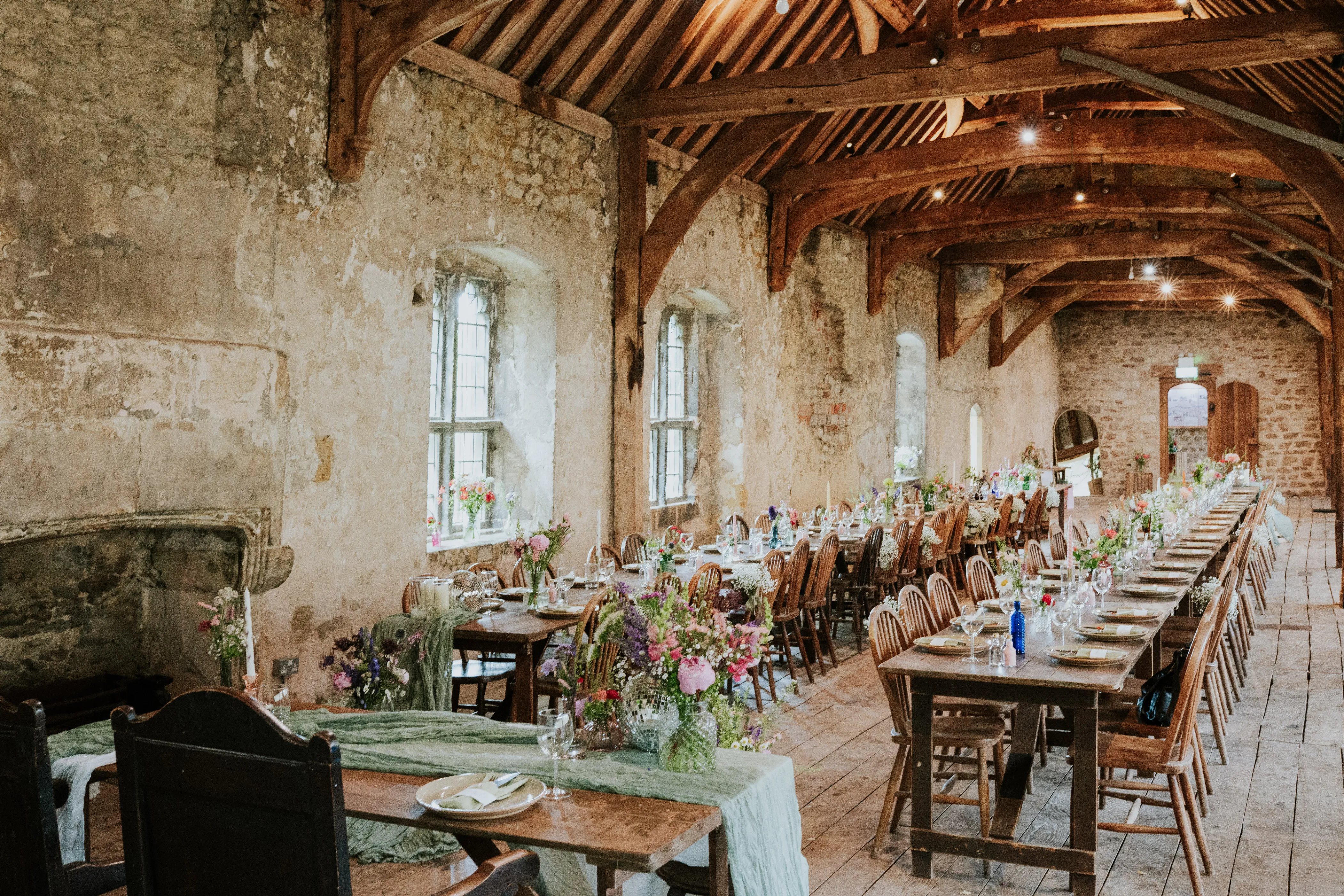 Stone barn fireplace wedding breakfast green table runners